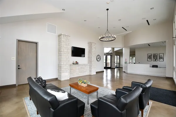 a living room with furniture a window and a flat screen tv