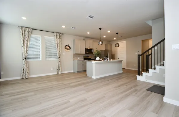 a view of a kitchen with a sink cabinets and wooden floor