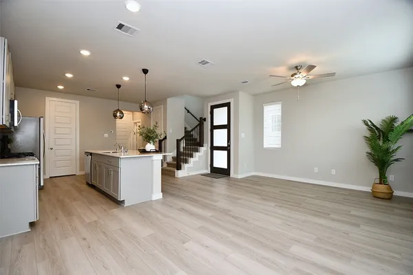 a view of kitchen with sink and wooden floor