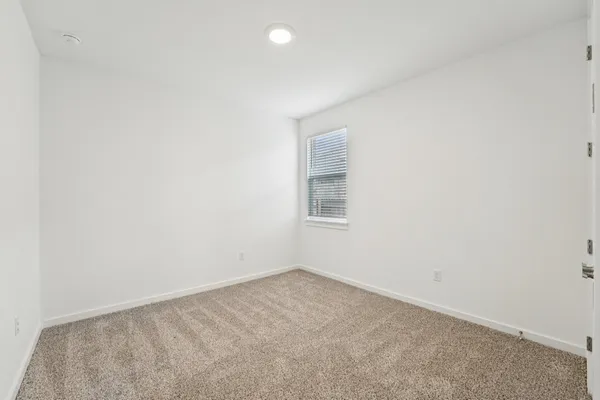 a large white kitchen with wooden floors stainless steel appliances and white cabinets