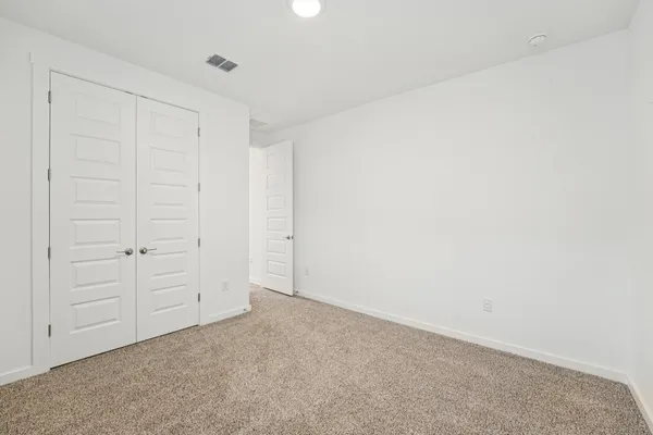 a large kitchen with stainless steel appliances lot of white cabinets