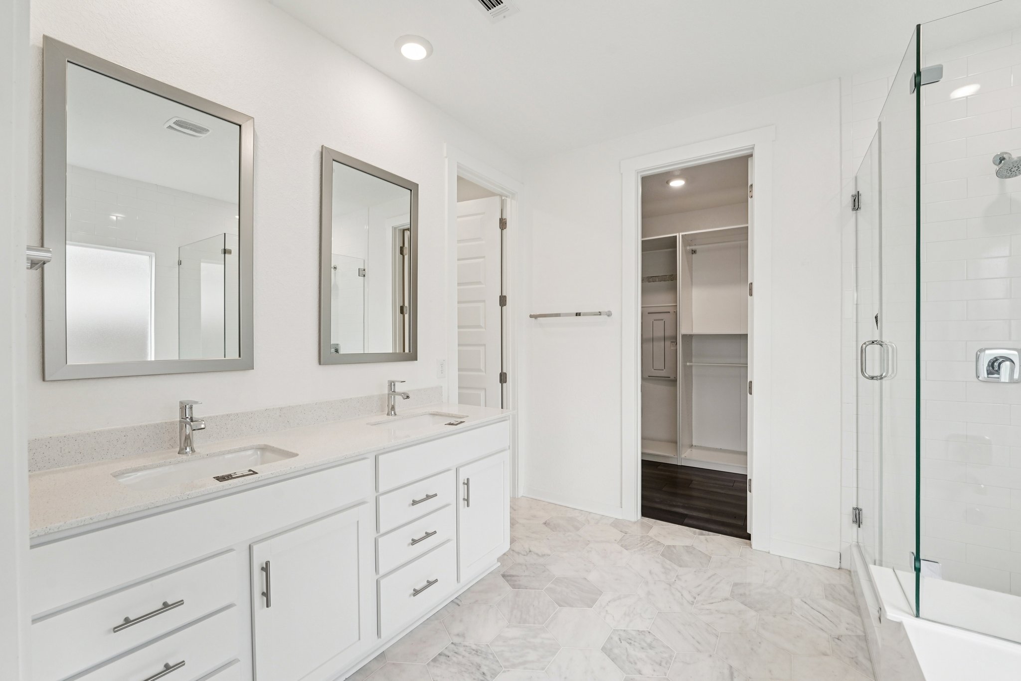 2233 Bravo Pass Leander, TX 78641 - Photo 16 of 33 Full bathroom with double vanity, a shower stall, recessed lighting, and a spacious closet