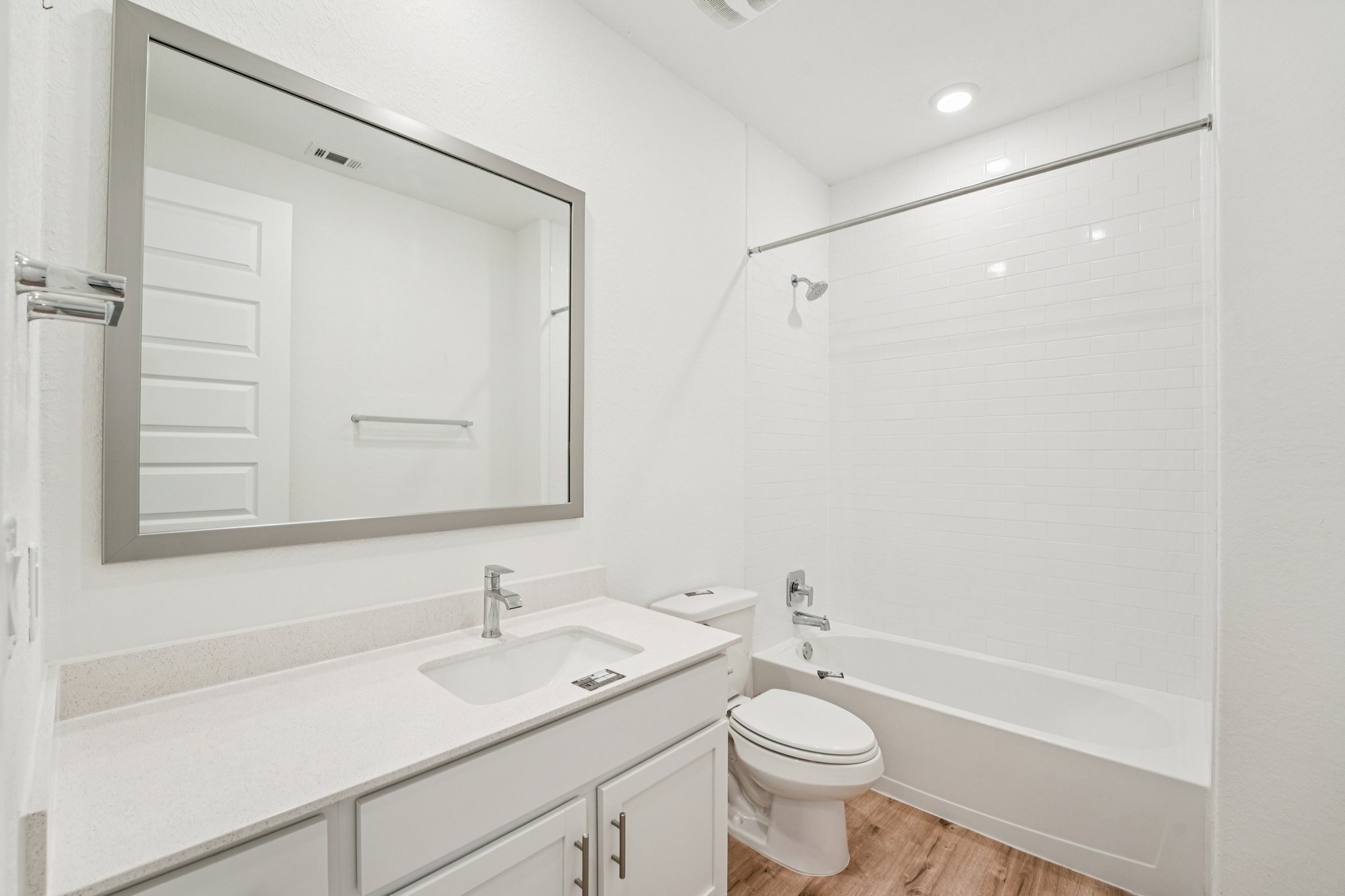 2233 Bravo Pass Leander, TX 78641 - Photo 19 of 33 Bathroom with light wood-type flooring, shower combination, vanity, and recessed lighting