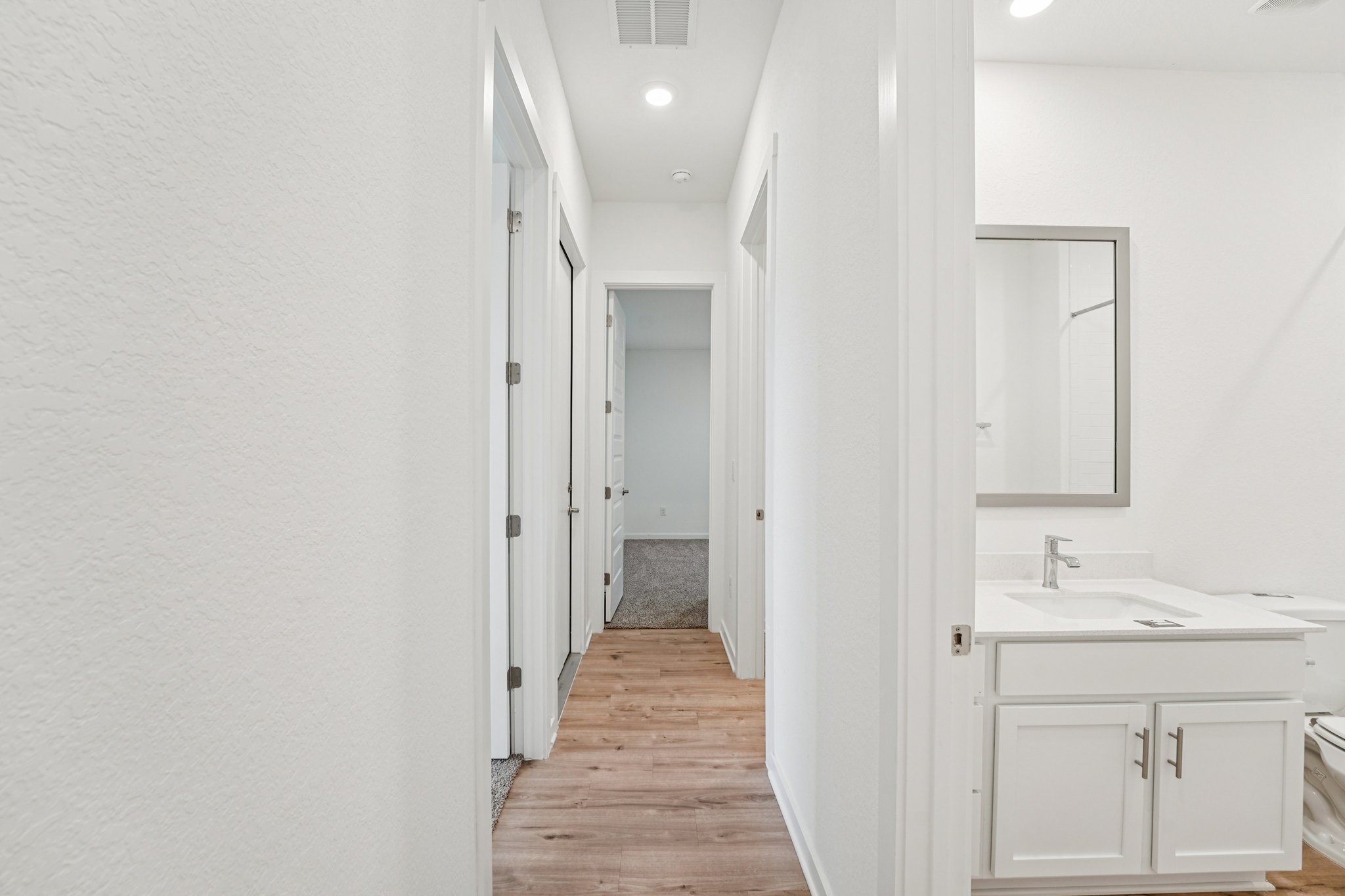 2233 Bravo Pass Leander, TX 78641 - Photo 20 of 33 Hall with light wood-style flooring and recessed lighting
