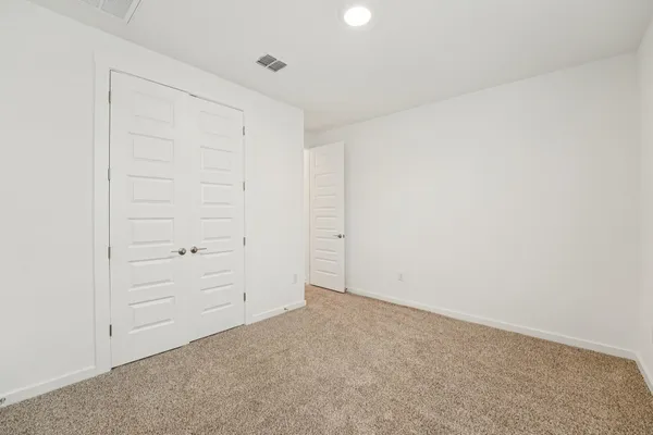 an empty room with closet area