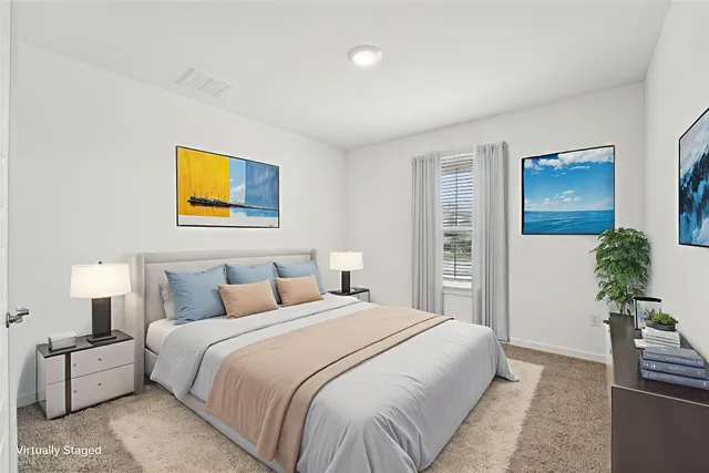 a bedroom with a bed and painting on the wall