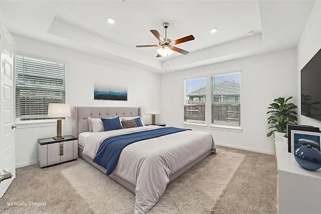 a spacious bedroom with a large bed and a chandelier