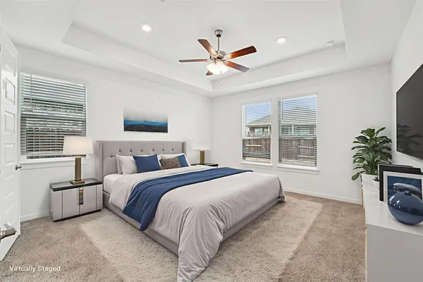 a spacious bedroom with a large bed and a chandelier
