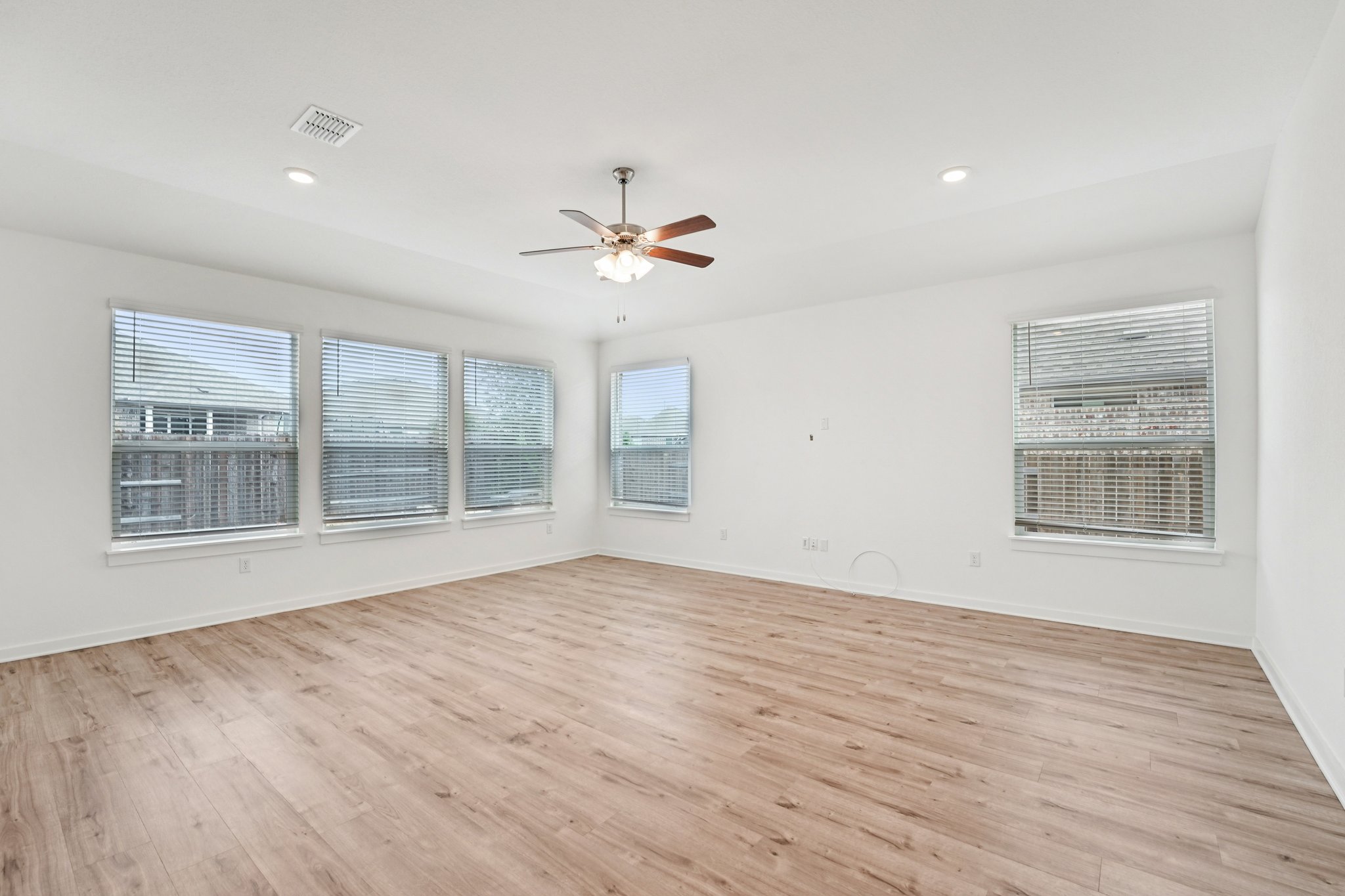 2233 Bravo Pass Leander, TX 78641 - Photo 5 of 33 Unfurnished room featuring light wood-style floors, recessed lighting, and a ceiling fan