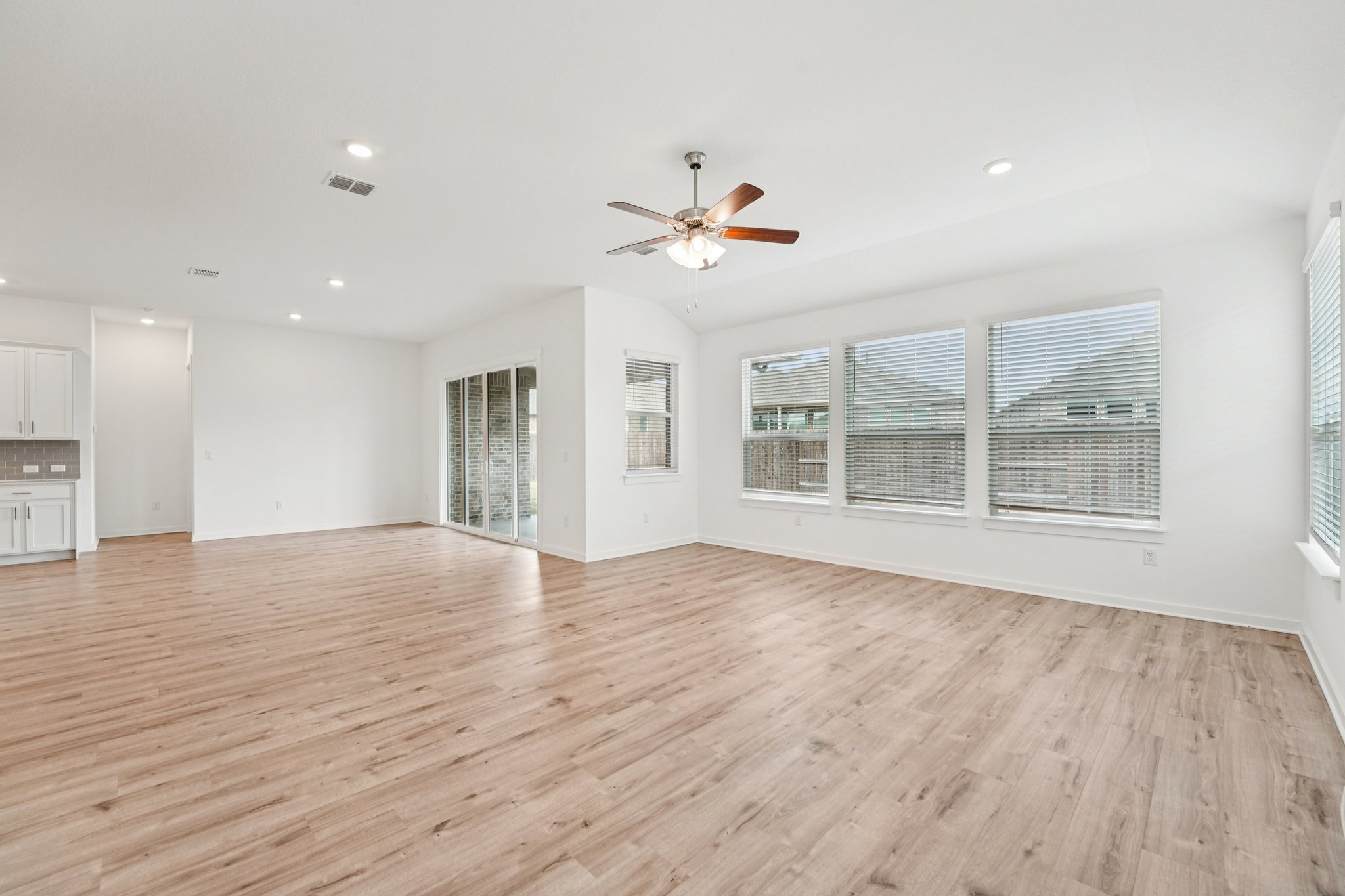 2233 Bravo Pass Leander, TX 78641 - Photo 6 of 33 Unfurnished living room featuring light wood-type flooring, recessed lighting, and a ceiling fan
