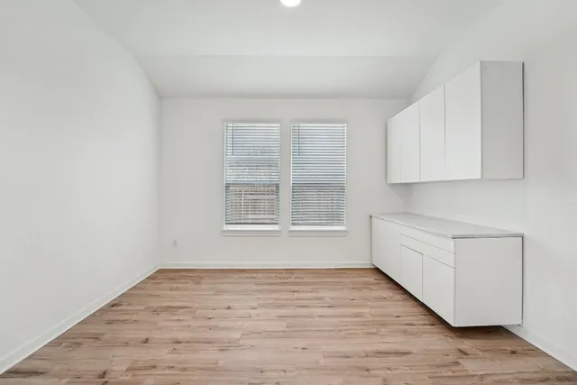 a view of kitchen with kitchen island wooden cabinets and stainless steel appliances