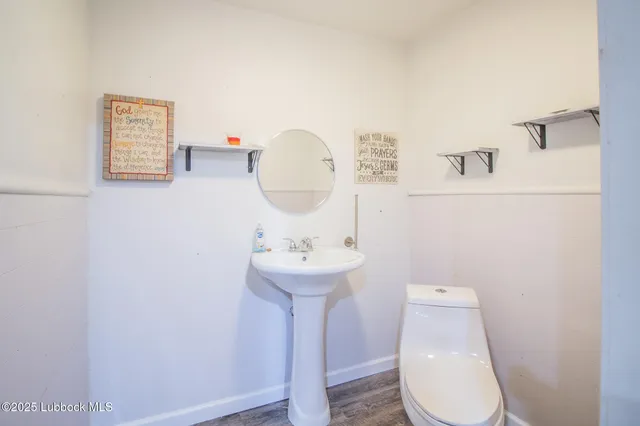 a bathroom with a sink mirror and toilet