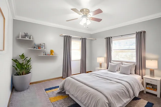 a bedroom with a bed and a potted plant