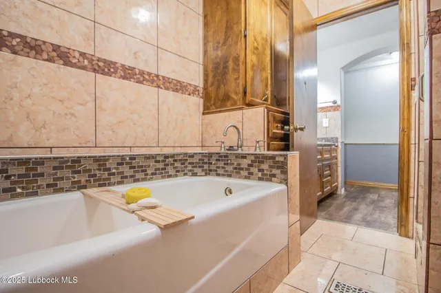 a bathroom with a bathtub and a sink