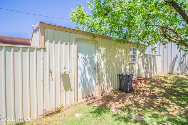 a view of a backyard with wooden fence