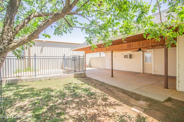 a view of a house with a small yard and wooden fence