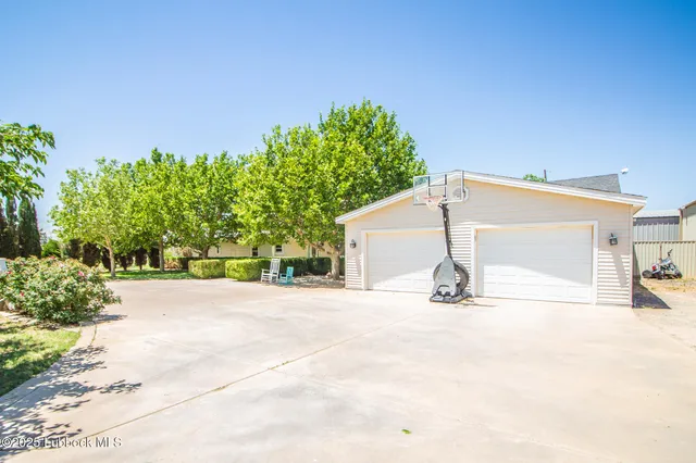 a view of a house with a yard and garage