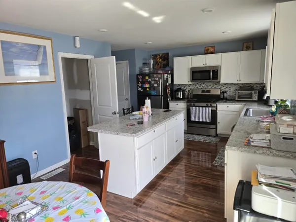 a kitchen with a sink stove and refrigerator