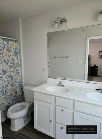 a bathroom with a toilet sink and mirror