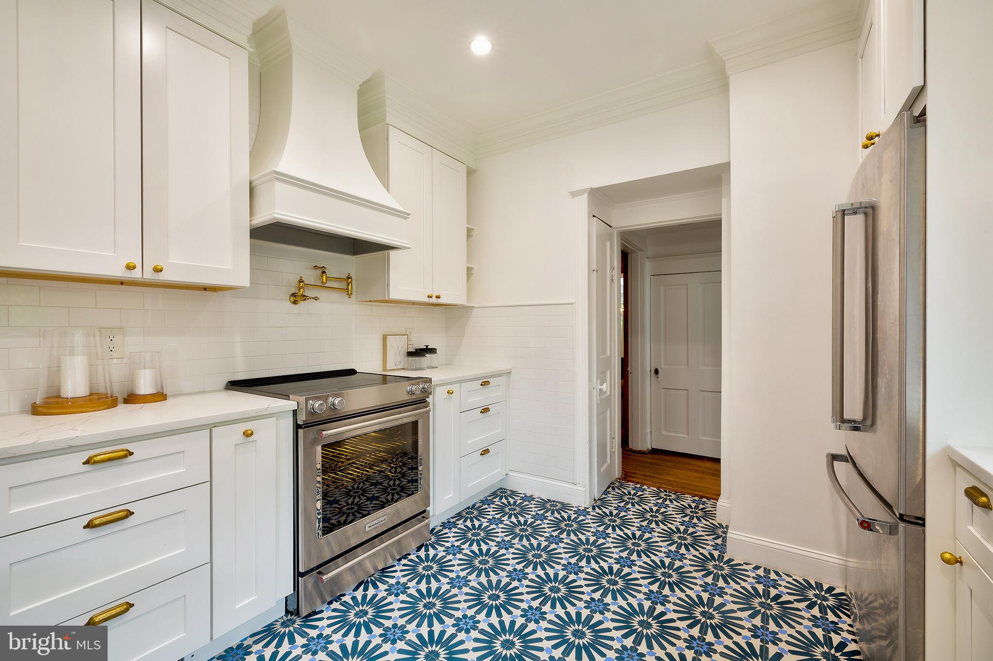 2925 Covington Road Silver Spring, MD 20910 - Photo 12 of 70 a kitchen with a stove and white cabinets