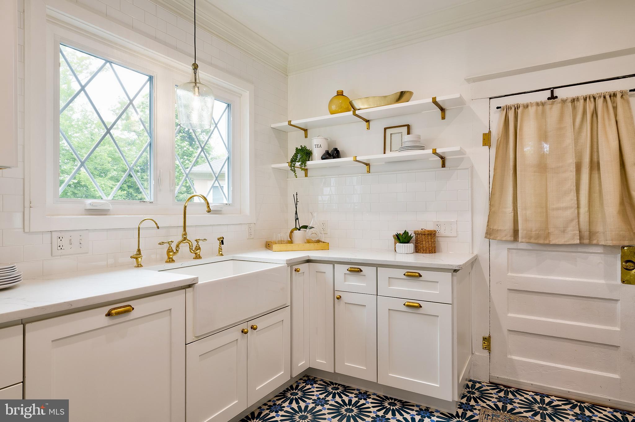 2925 Covington Road Silver Spring, MD 20910 - Photo 16 of 70 a kitchen with a sink dishwasher and white cabinets with wooden floor