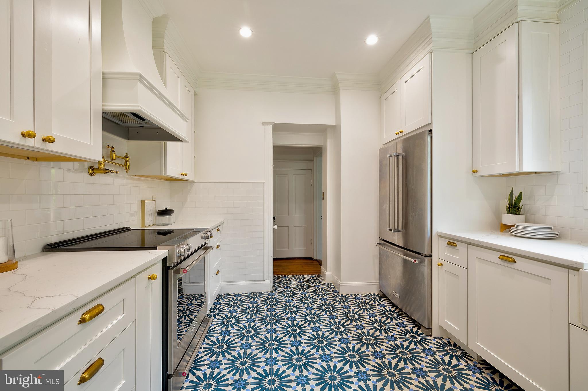 2925 Covington Road Silver Spring, MD 20910 - Photo 19 of 70 a kitchen with a sink a refrigerator and cabinets