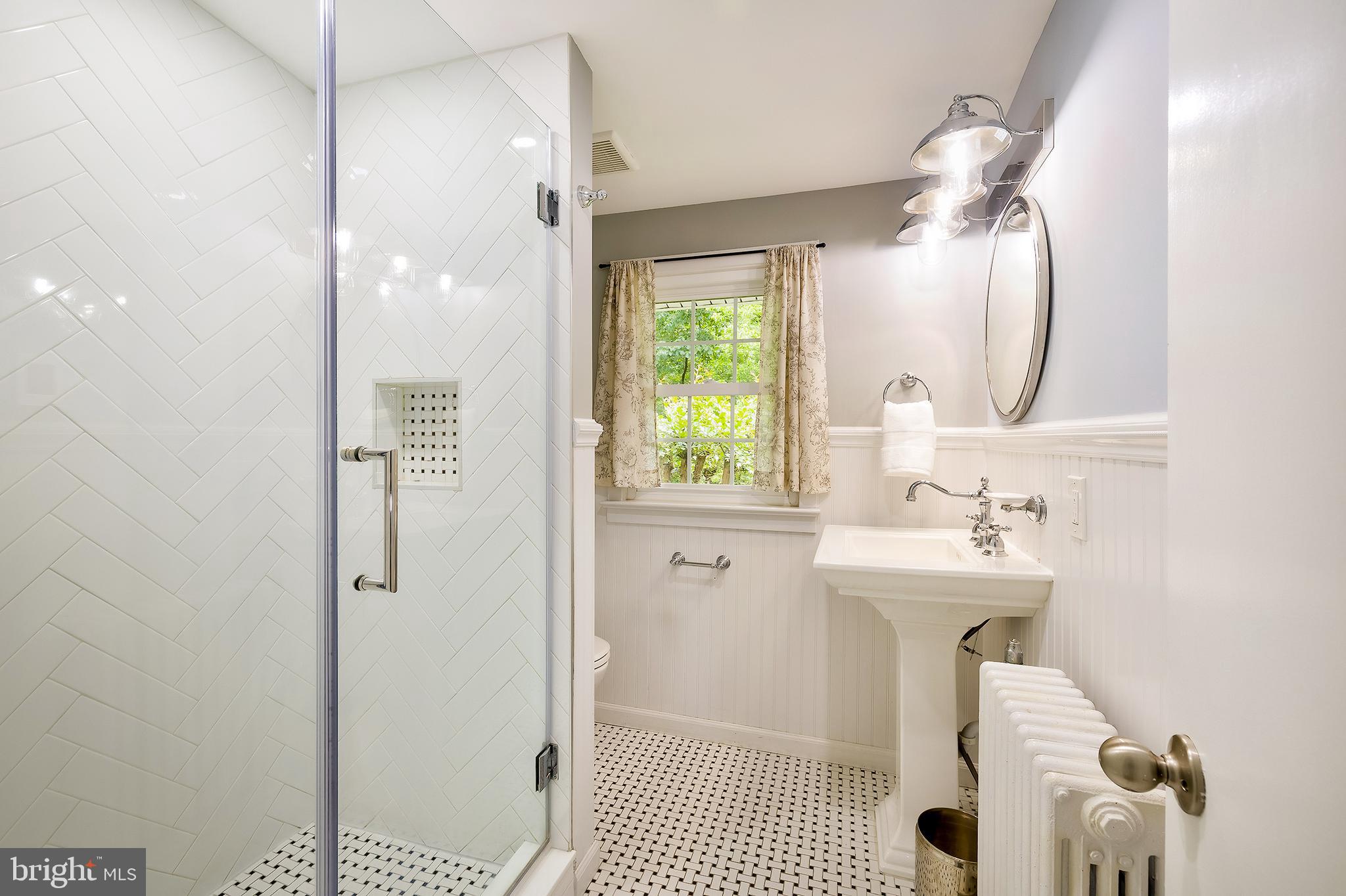 2925 Covington Road Silver Spring, MD 20910 - Photo 28 of 70 a bathroom with a sink a toilet and shower