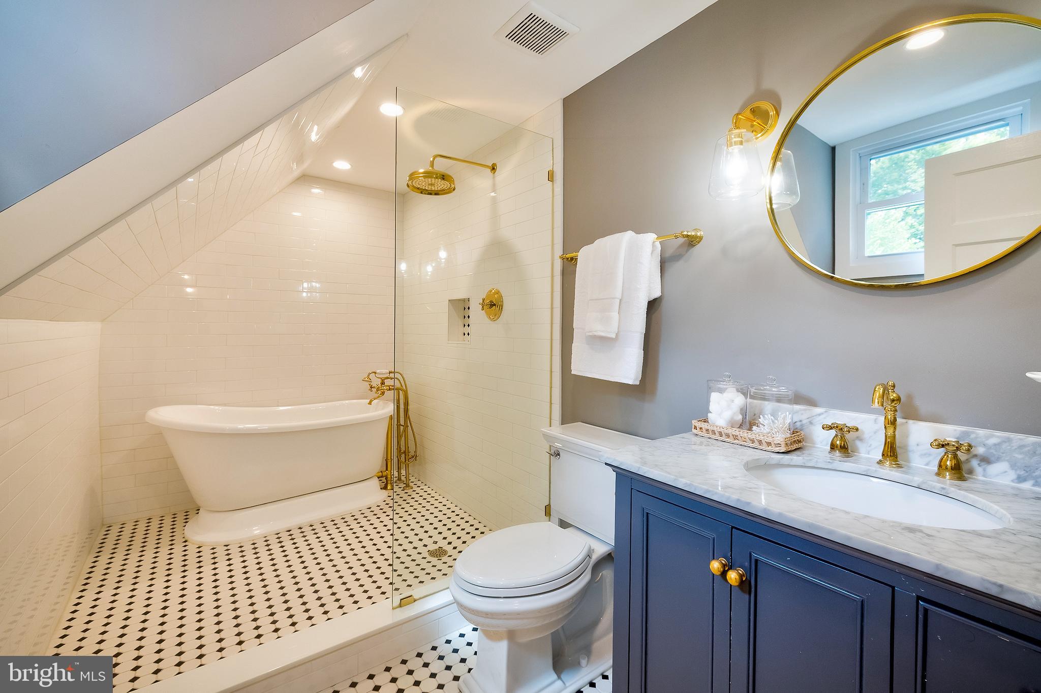 2925 Covington Road Silver Spring, MD 20910 - Photo 37 of 70 a bathroom with a sink a toilet and a mirror