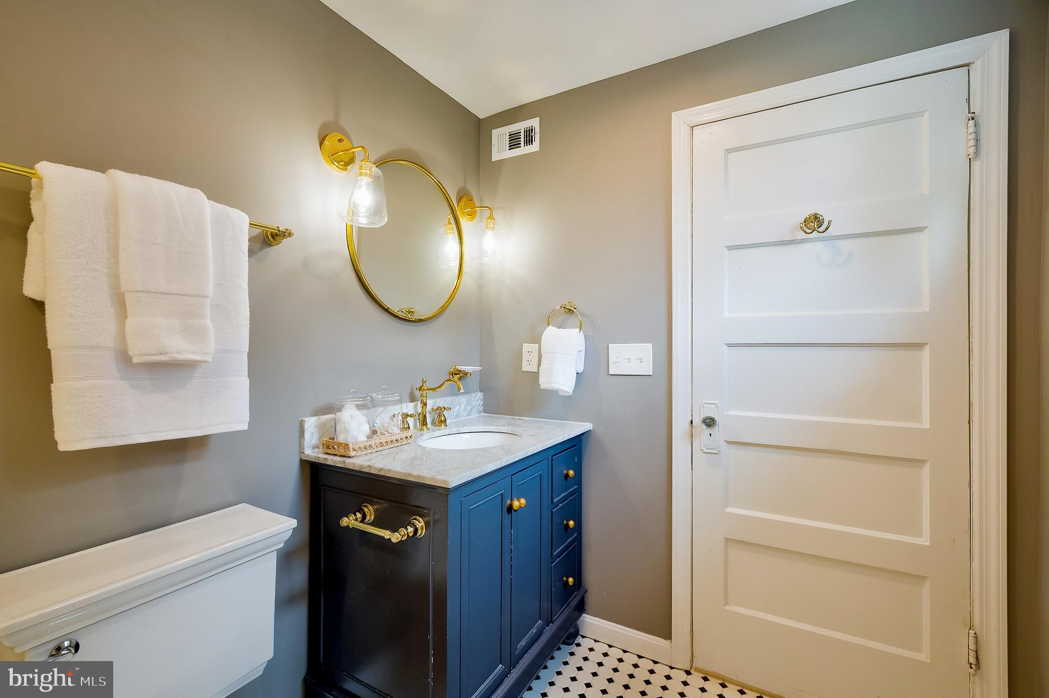 2925 Covington Road Silver Spring, MD 20910 - Photo 39 of 70 a bathroom with a sink a toilet and a mirror