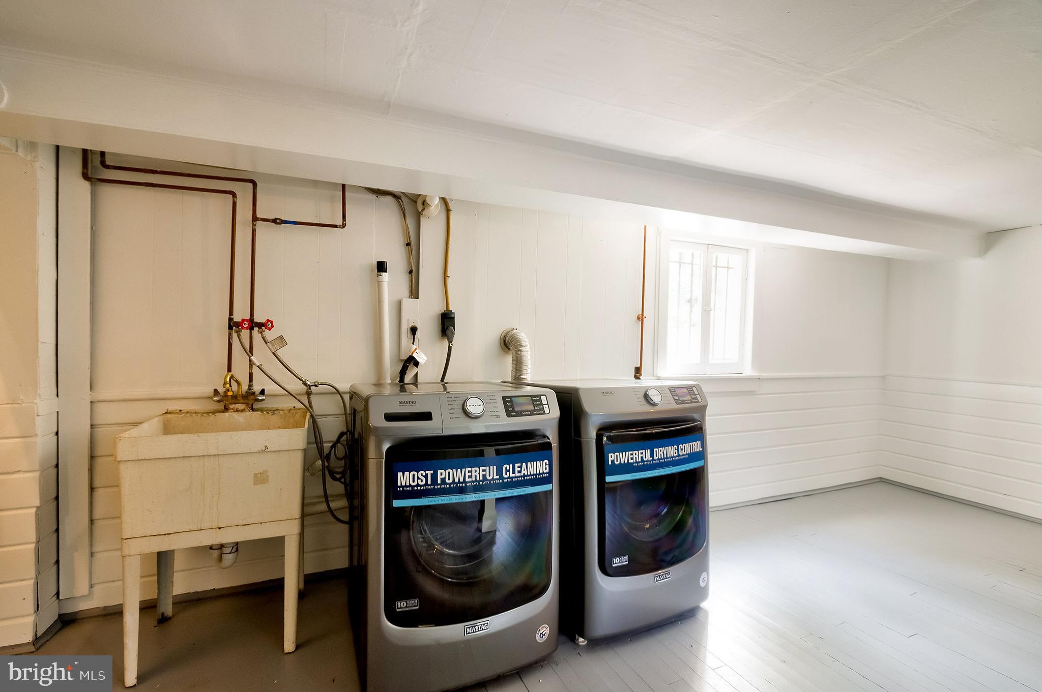 2925 Covington Road Silver Spring, MD 20910 - Photo 50 of 70 a utility room with cabinets dryer and washer
