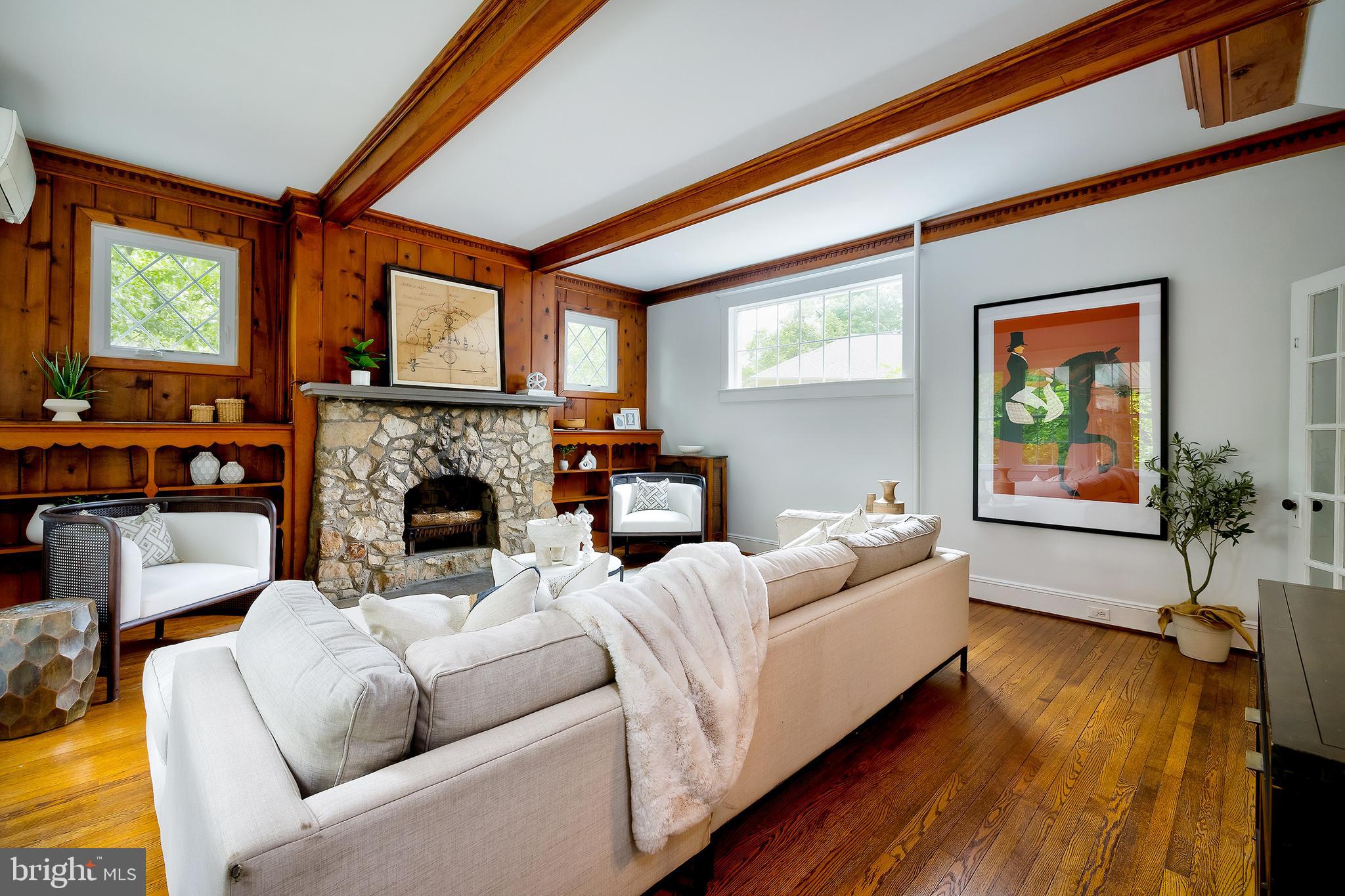 2925 Covington Road Silver Spring, MD 20910 - Photo 8 of 70 a living room with furniture a fireplace and a floor to ceiling window