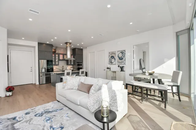 a living room with furniture and kitchen view