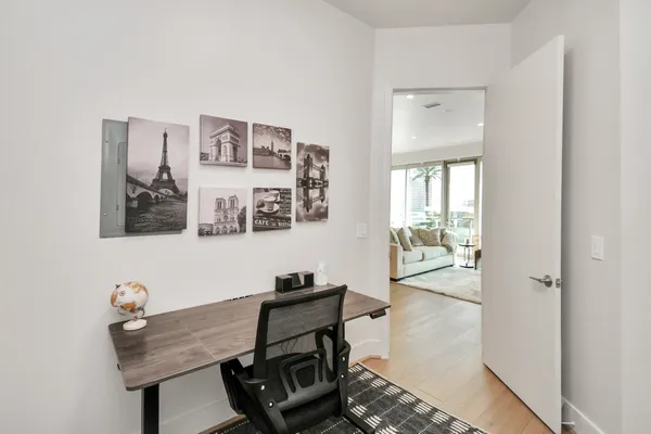 a living room with furniture and wooden floor