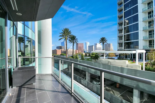 a view of balcony with furniture and potted plants