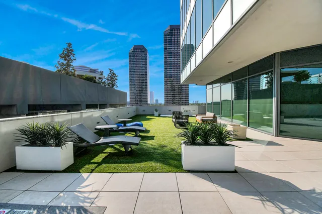a view of a patio with couches and potted plants