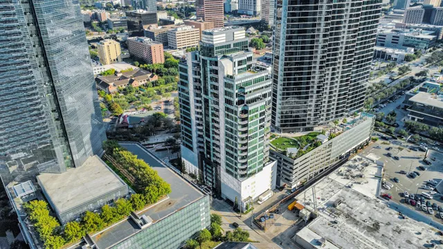 a bird view of multi story residential apartment building with yard