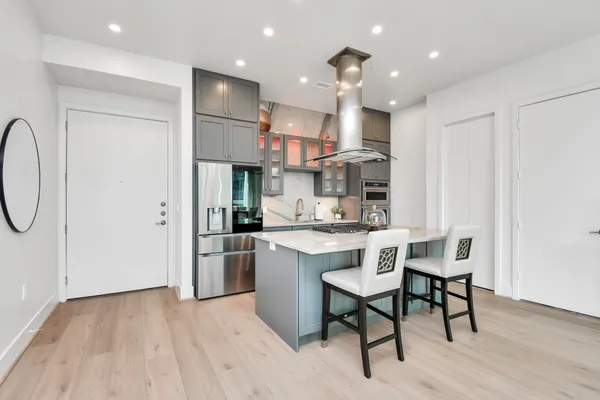 a kitchen with stainless steel appliances granite countertop a sink refrigerator and cabinets