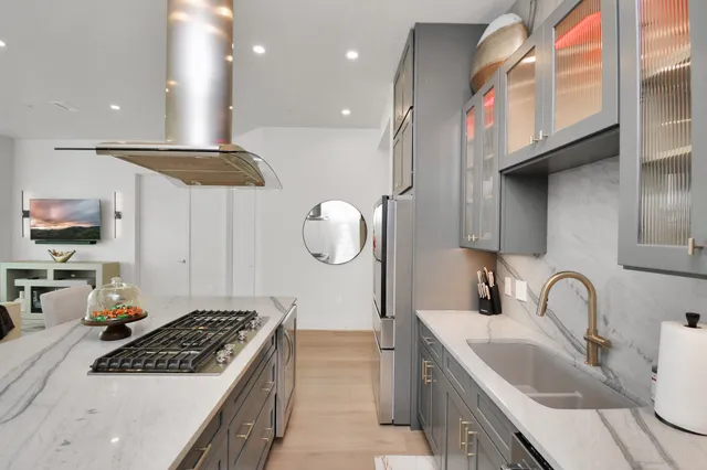 a kitchen with a sink a stove and cabinets