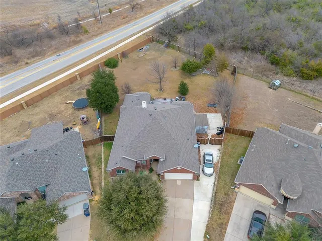 an aerial view of a house with a yard
