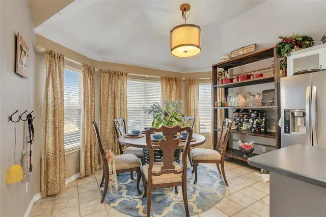 a view of a dining room with furniture and a window