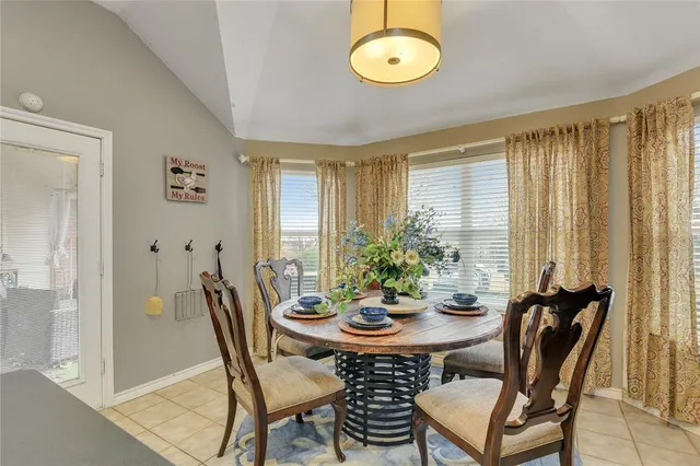 a view of a dining room with furniture and window