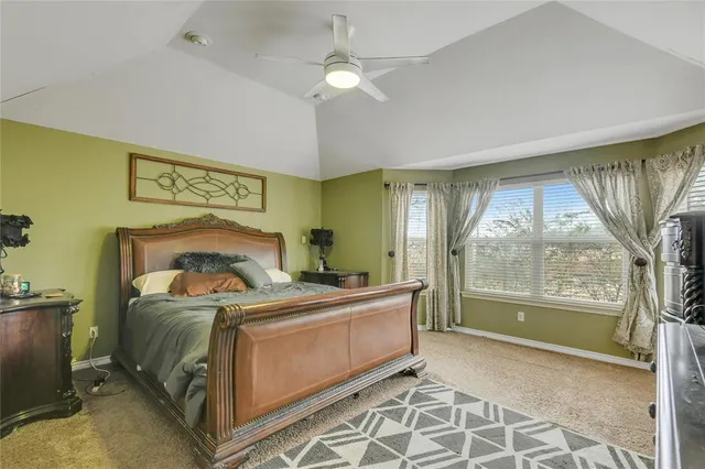 a bed room with a bed and a chair