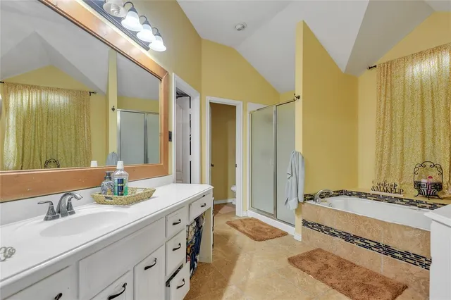 a spacious bathroom with a granite countertop sink and a mirror