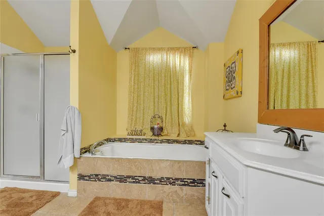 a bathroom with a tub and a sink