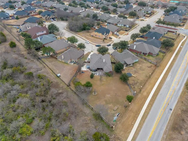 an aerial view of residential houses with outdoor space