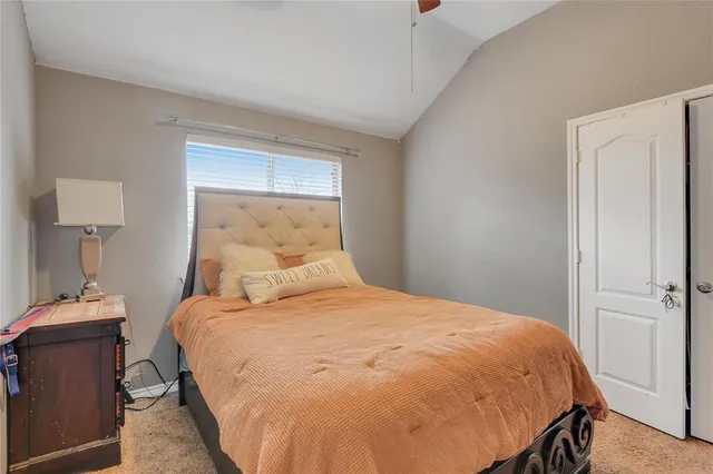 a large bed sitting in a bedroom next to a lamp