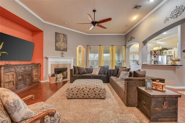 a living room with furniture a fireplace and a flat screen tv