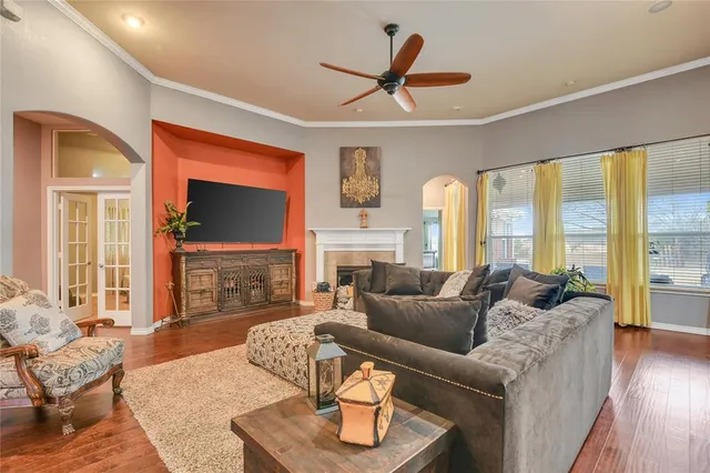 a living room with fireplace furniture and a flat screen tv