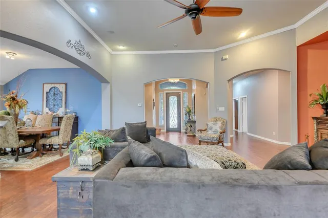 a living room with furniture and a chandelier