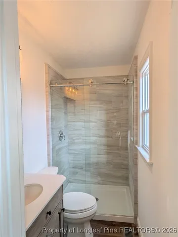 a bathroom with a shower and a toilet